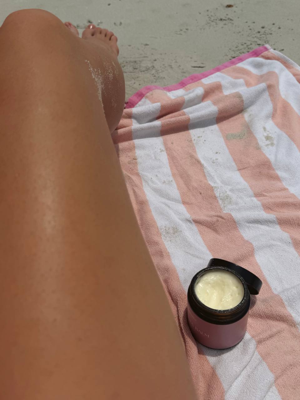 Sun-warmed skin and Nadarra Balm on the beach